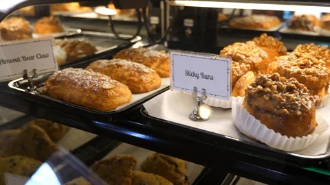 Baked goods in display window in bakery with labels croissants muffins buns Stock-Footage 89358159