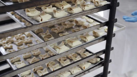 Baked goods with jam are placed on baking sheets before being sent to the oven Stock Footage 321132374
