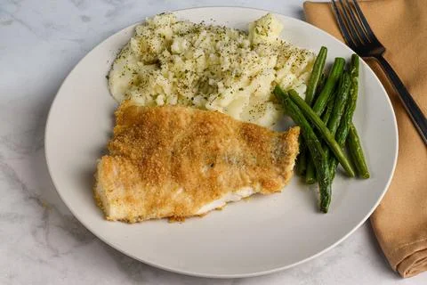 Baked haddock served with  mashed  potatoes and green beans Stock Photos
