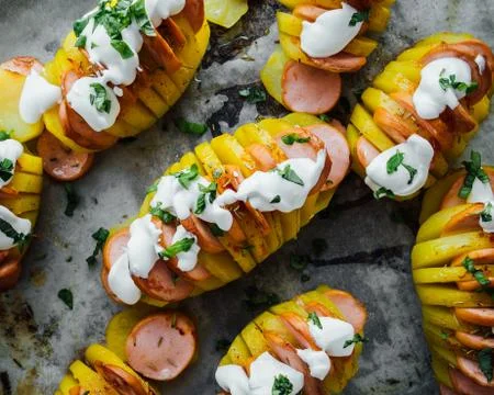 Baked hasselback potatoes Stock Photos