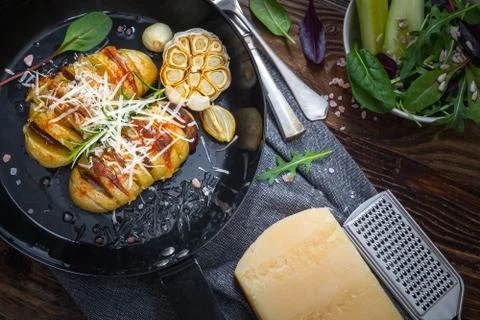 Baked hasselback potatoes. Stock Photos