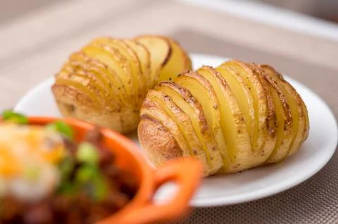 Baked hasselback potatoes Stock Photos