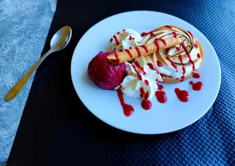 Baked Lemon Pie with blackcurrant cassis flavor ice cream next to it Stock Photos