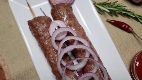 Baked lula kebab on rectangular dish on a rustic table 스톡 동영상 242761903