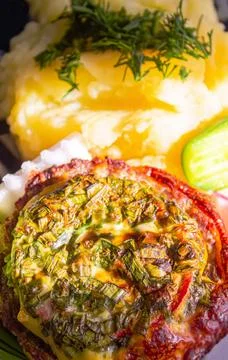 Baked meat with cheese and mashed potatoes with fresh vegetables as a side dish Stock Photos