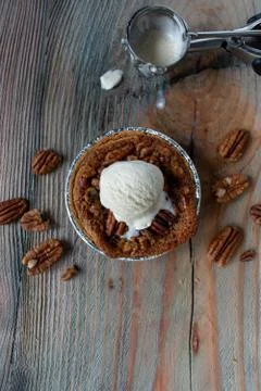Baked mini pecan pies on rustic table Stock Photos