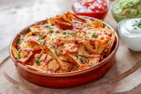 Baked nacho chips with dips Stock Photos