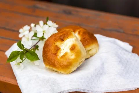 Baked open rolls on a dark, worn rustic wooden table. The composition is deco Stock Photos