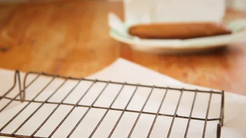 Baked orange cake being kept on cooling rack Stock Footage 76198231