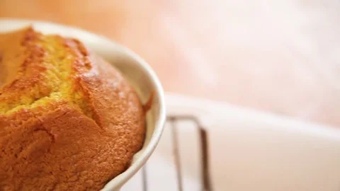 Baked orange cake on cooling rack Stock Footage 76198247