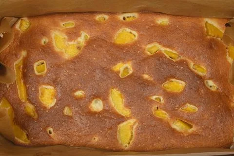 Baked peach sponge cake in a baking pan full frame Stock Photos