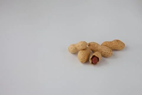 Baked peanuts in shell on white background Stock Photos