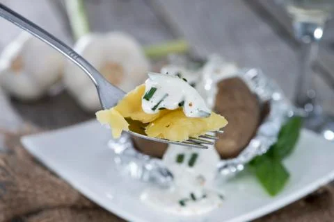 Baked potato on a fork Stock Photos