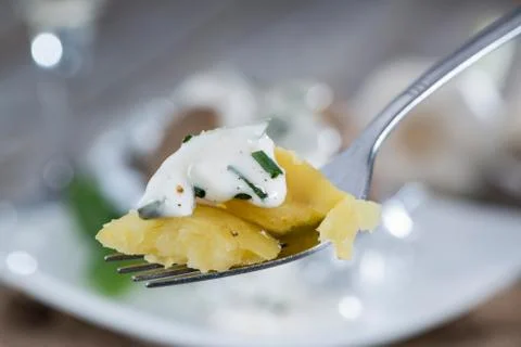 Baked potato on a fork Stock Photos