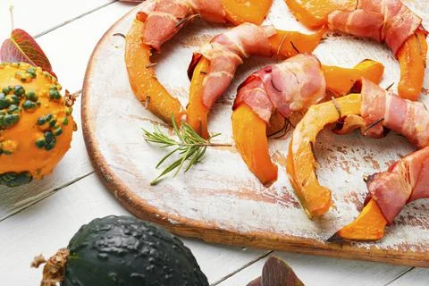 Baked pumpkin in bacon. Stock Photos