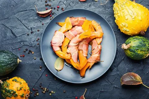 Baked pumpkin in bacon. Stock Photos