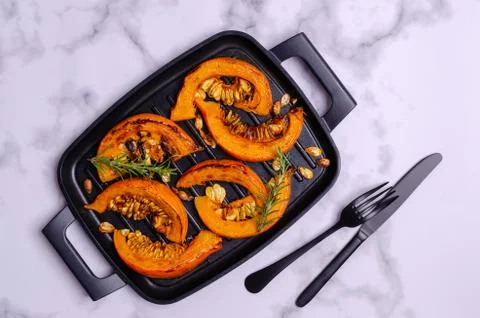 Baked pumpkin slices with seeds Stock Photos