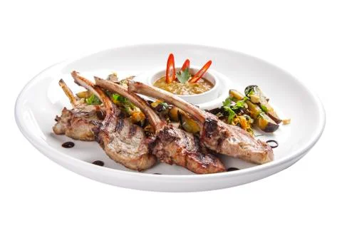Baked rack of lamb with onions on a white plate Stock Photos