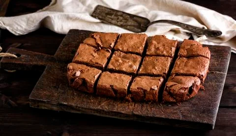 Baked rectangular chocolate brownie pie is cut into squares 스톡 사진