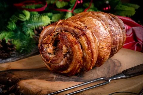 Baked rolled bacon. Stock Photos