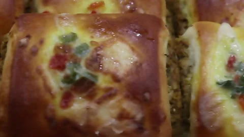 Baked rolls close up with melted cheese and colorful vegetables arranged Stock Footage 338163939