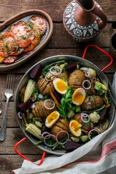Baked root vegetables in a pan, rustic style Stock Photos