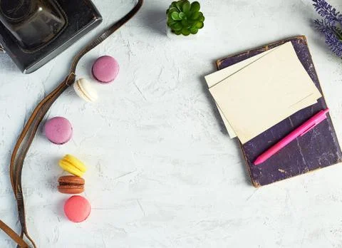 Baked round macarons, notebook, pen and plants in a pot Fotos Stock