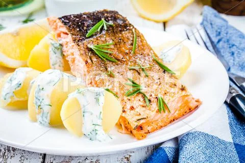 Baked salmon fillet and boiled potatoes Stock Photos