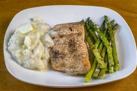 Baked salmon with garlic mashed potatoes and asparagus Stock Photos