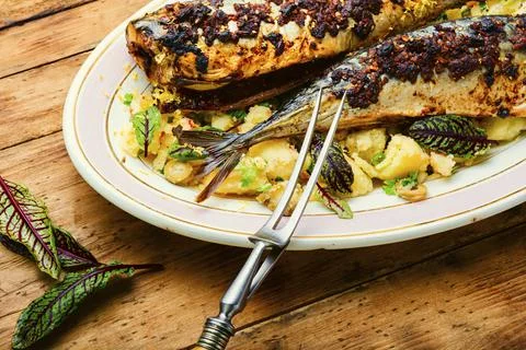 Baked scomber with potatoes Stock Photos