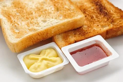 Baked slices of bread with jam and butter Stock Photos