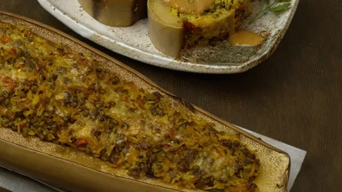 Baked squash stuffed with basmati rice, tomatoes, mung beans, and cheese. Stock Footage 331290192