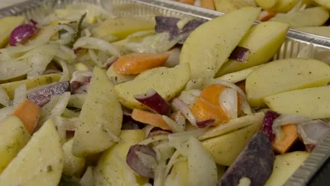 Baked vegetables - cut potatoes red onion carrots Stock Footage 269701409