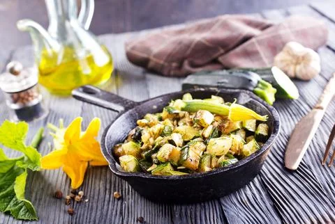 Baked vegetables in pan on a table, close up view Stock Photos