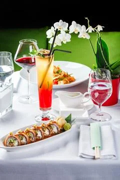 Baked warm sushi rolls with eel, cucumber and smoked salmon Stock Photos