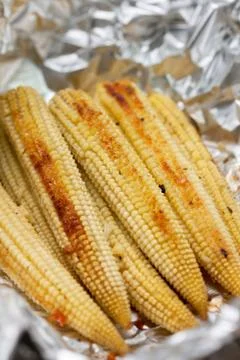 Baked young corn cobs Stock Photos
