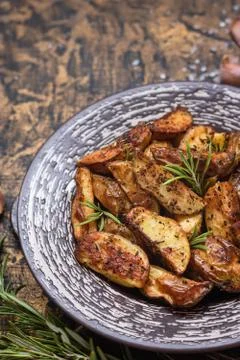 Baked young potatoes in a rustic style with sour cream Stock Photos