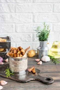Baked young potatoes in a rustic style with sour cream Stock Photos