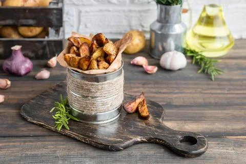 Baked young potatoes in a rustic style with sour cream Stock Photos