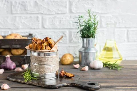 Baked young potatoes in a rustic style with sour cream Stock Photos
