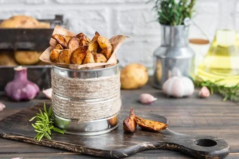 Baked young potatoes in a rustic style with sour cream Stock Photos