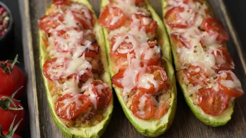 Baked zucchini half with minced meat, tomatoes, cheese, salt, and spices. Zucchi Stock Footage 336405482