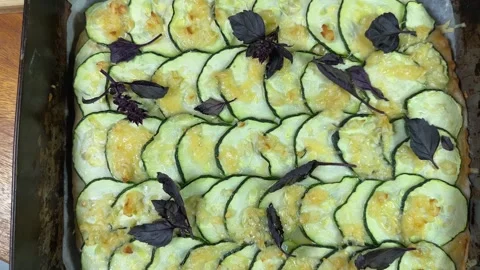 Baked zucchini pizza in deep baking sheet, top view Stock Footage 320257700