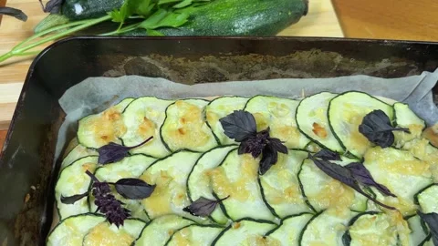 Baked zucchini pizza in deep baking sheet and raw zucchini Stock Footage 320257797
