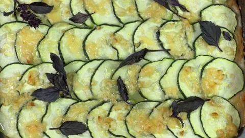 Baked zucchini pizza in deep baking sheet close-up Stock Footage 320257854