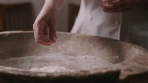 Baker adding ingredients to dough Stock Footage 130390433