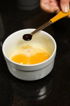 Baker adding ingredients to mix Foto stock