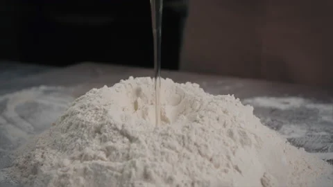 The baker adds a raw egg to the dough. Slow motion Stock Footage 201546852