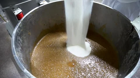 Baker adds sugar and additives to the flour with sourdough in the dough mixer. Stock Footage 252931443