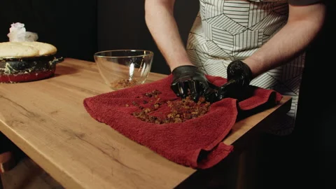 Baker in apron mixes ingredients manually during baking process 库存影片 330536648
